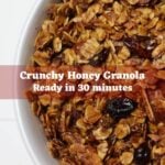 Bowl of baked granola with text overlay Crunchy Honey Granola Ready in 30 minutes.