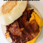 Bacon and egg muffin sandwich with melted cheese and text overlay reading Bacon, Egg, & Cheese Breakfast Sandwich.