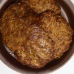 Homemade sweet Italian sausage patties stacked in a brown dish with “Homemade Sweet Italian Sausage Recipe” overlay text.