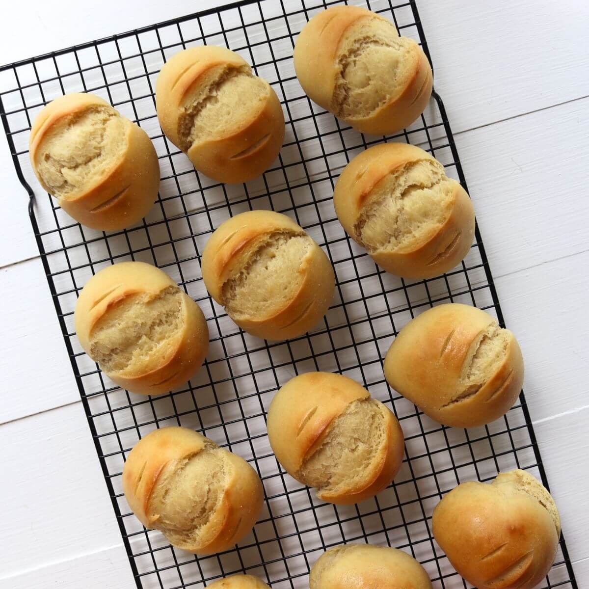 Buttermilk dinner rolls cooling on a wire rack.