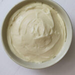 Bowl of honey whipped cream cheese with text reading "Honey Whipped Cream Cheese Recipe".