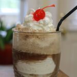 Old fashioned ice cream float with whipped cream and cherry. Text overlay: Old Fashioned Ice Cream Float.