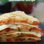 Stacked grilled cheese and tomato quesadilla wedges on a black board. Text overlay reads "Grilled Cheese and Tomato Quesadilla Recipe".
