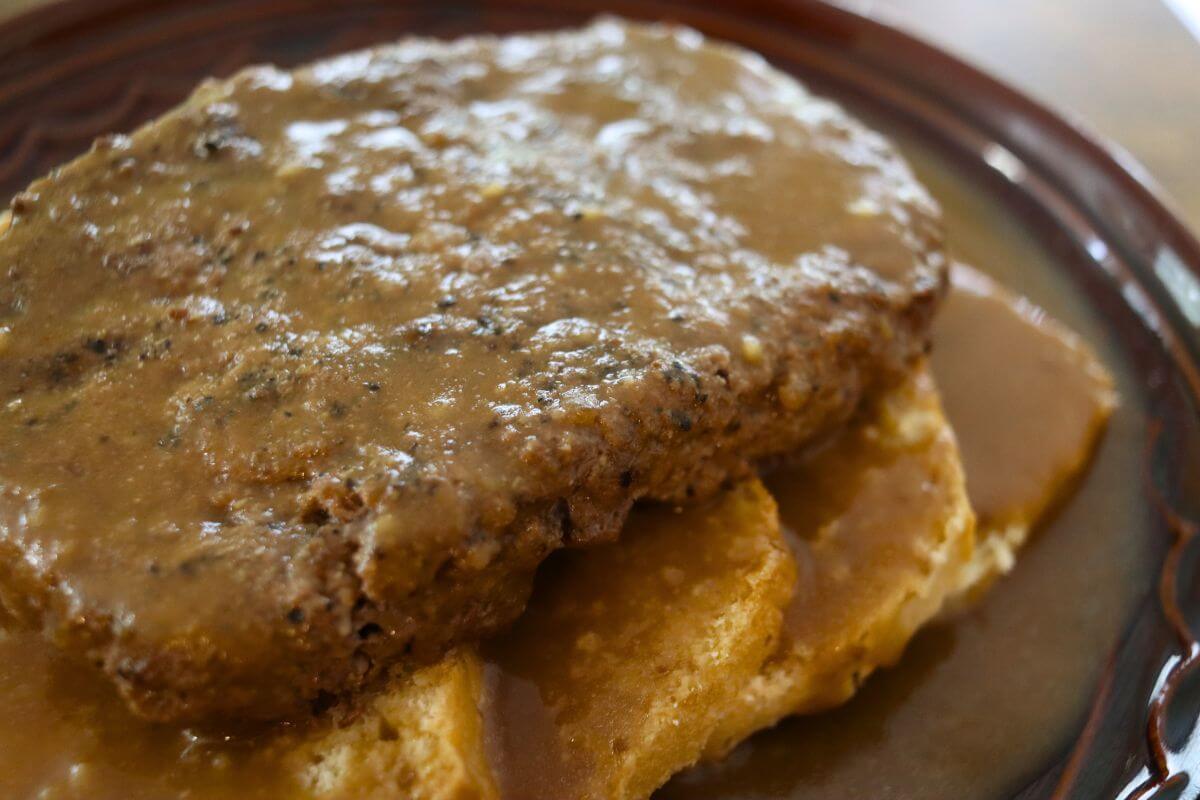 Homemade hot hamburger sandwich covered in brown gravy over white sandwich bread.