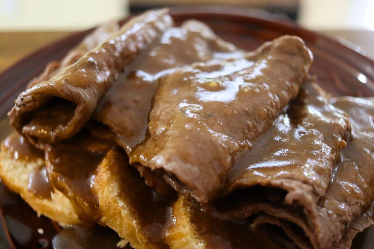 Thin slices of roast beef layered over white bread and topped with rich brown gravy.