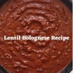 Thick tomato-based sauce in a black cast iron Dutch oven with the text "Lentil Bolognese Recipe".