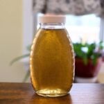 Homemade vanilla simple syrup with vanilla bean specks stored in a glass bottle.