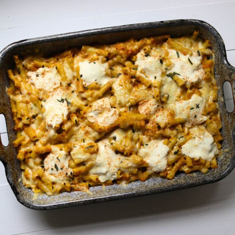 Baked pumpkin pasta with ziti, melted cheese, ricotta, fresh herbs, and smoked paprika.