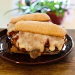 Eggplant sandwich with crispy breaded eggplant, marinara sauce, and melted Monterey Jack cheese on a toasted baguette.