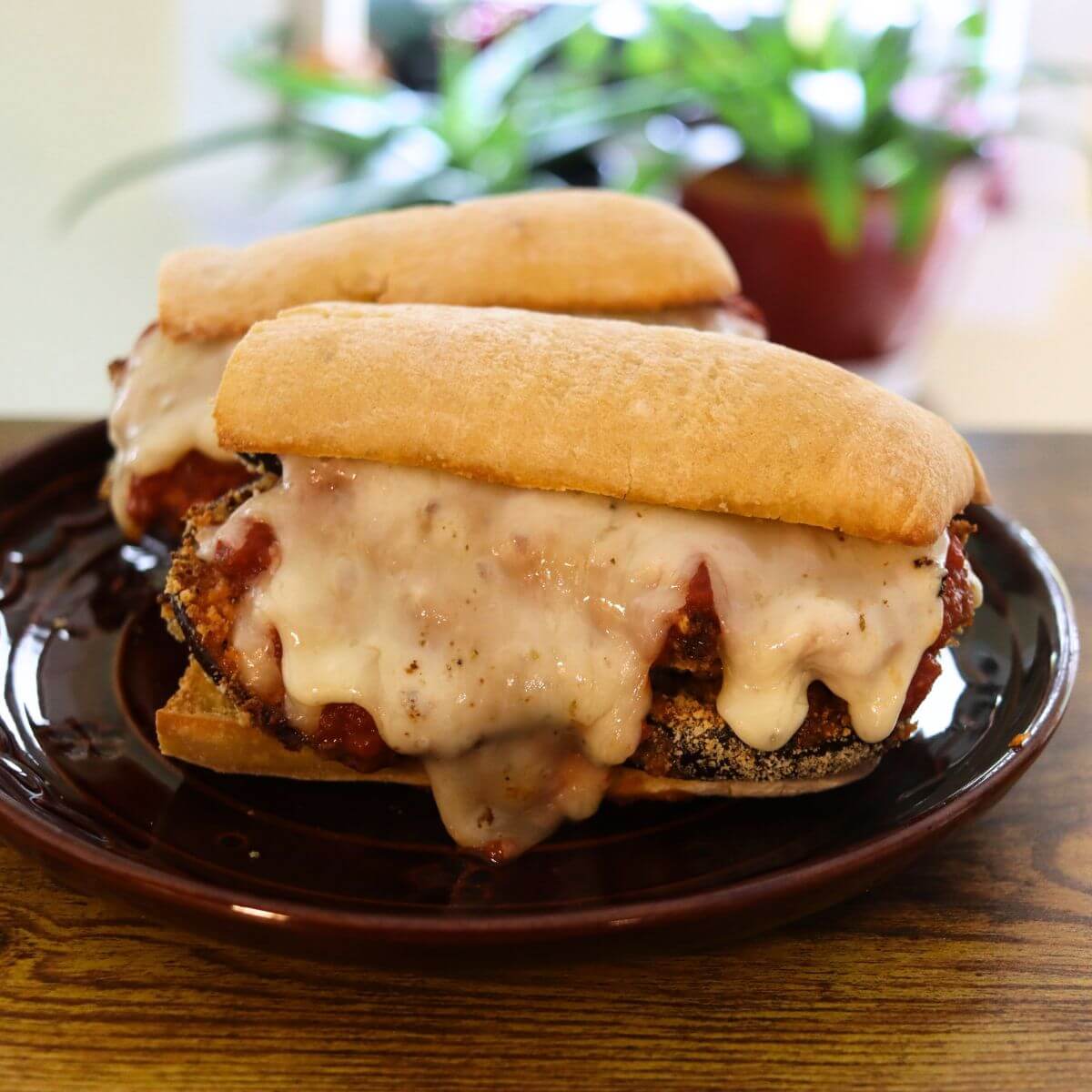 Eggplant sandwich with crispy breaded eggplant, marinara sauce, and melted Monterey Jack cheese on a toasted baguette.