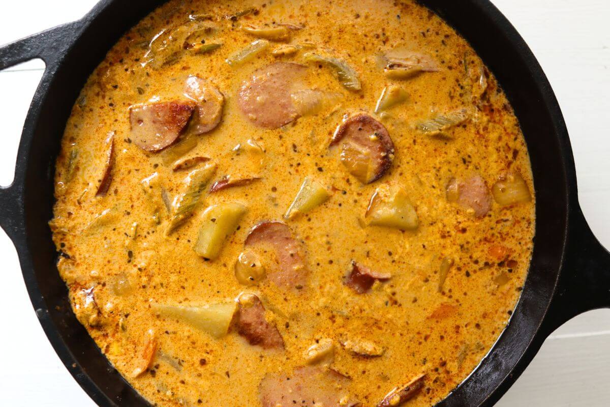 Homemade kielbasa potato soup with browned kielbasa and potato chunks in a creamy seasoned broth.