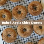 Baked apple cider donuts coated with cinnamon sugar on a wire rack with “Baked Apple Cider Donuts” text.