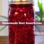Glass mason jar filled with vibrant red beet sauerkraut and fitted with a fermentation lid, with text overlay reading Homemade Beet Sauerkraut.