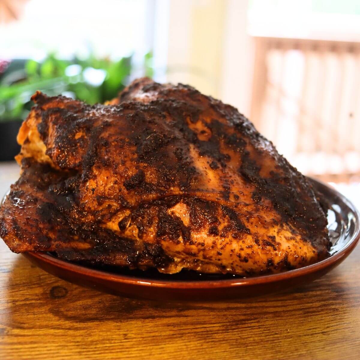 Cajun turkey breast with browned skin and a dark Cajun spice crust.