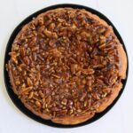 Pecan rolls topped with sticky maple brown sugar glaze and chopped pecans.