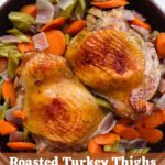 Roasted turkey thighs with carrots, celery, and onions in a black serving bowl, with text overlay reading “Roasted Turkey Thighs (with Apple Cider Brine)".