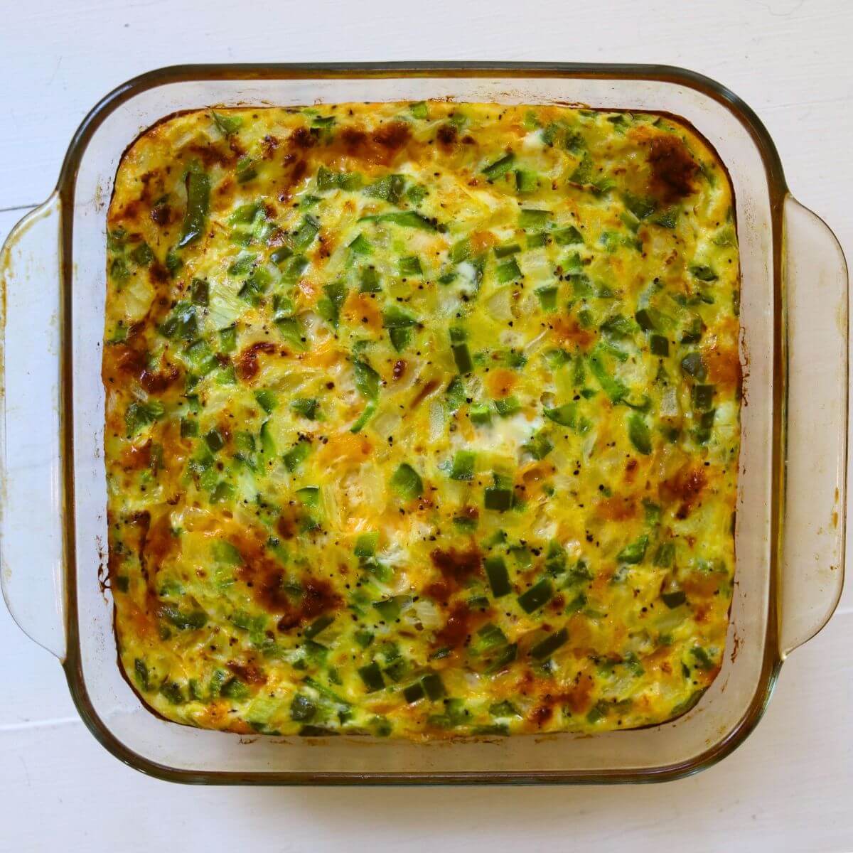 Western egg casserole with green peppers, onions, and browned melted cheese fresh from the oven.