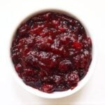 Cranberry compote with whole cranberries in a thick, glossy, deep red sauce.