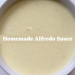 Creamy homemade Alfredo sauce in a ceramic bowl with “Homemade Alfredo Sauce” text overlay.
