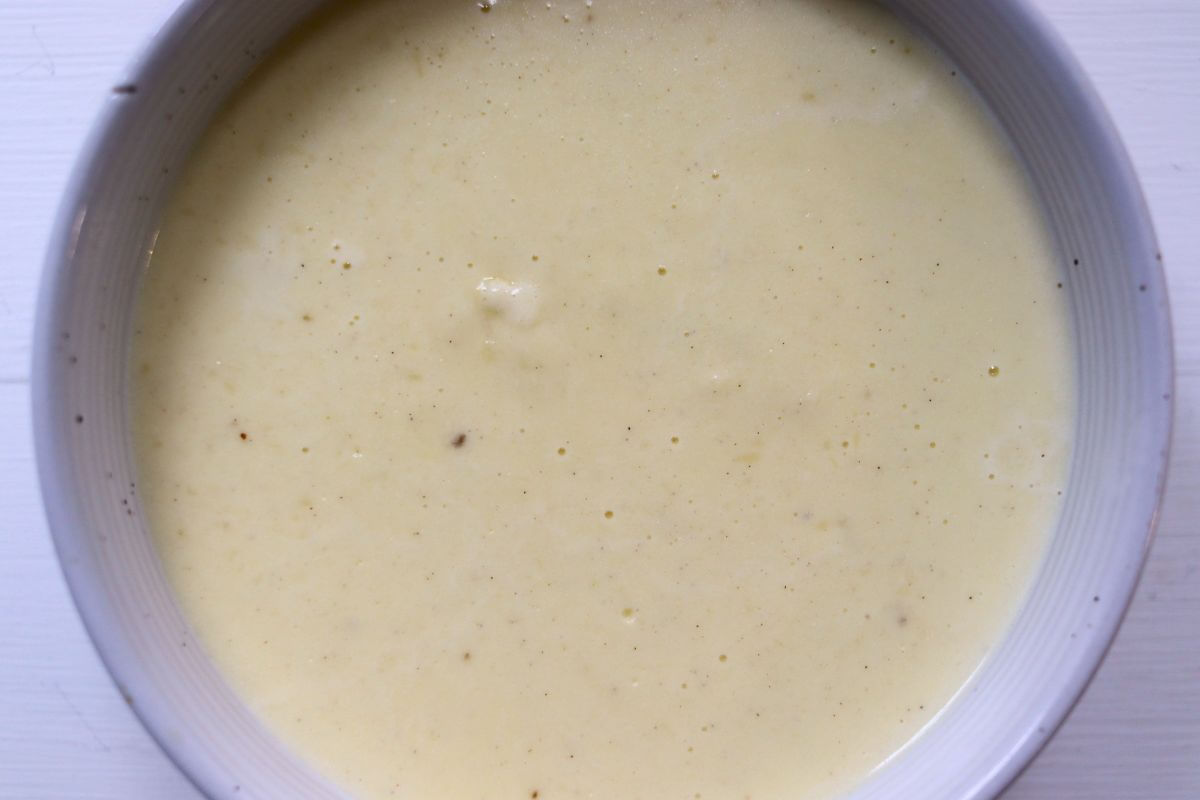 Easy homemade alfredo sauce in a white ceramic bowl.