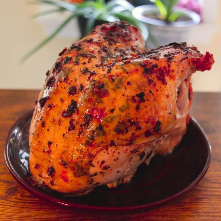 Oven roasted turkey breast with golden, buttery skin speckled with fresh herbs and dark roasted bits.