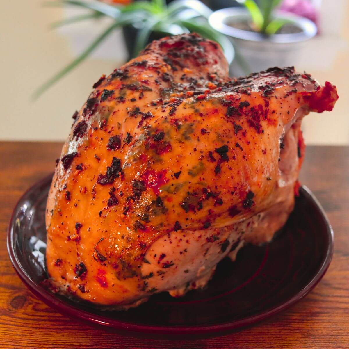 Oven roasted turkey breast with golden, buttery skin speckled with fresh herbs and dark roasted bits.