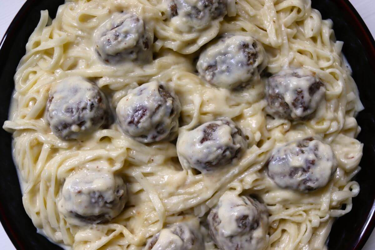 Homemade turkey meatballs and flat noodles coated in creamy alfredo sauce.
